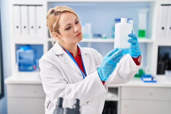 Young Blonde Woman Scientist Holding Bottle Laboratory — Stock Photo, Image