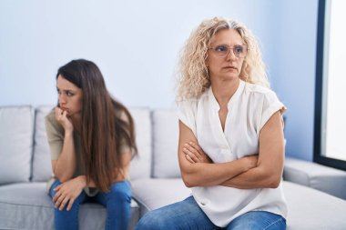 Two women mother and daughter arguing at home