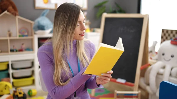 Young Blonde Woman Preschool Teacher Reading Book Kindergarten — ストック写真