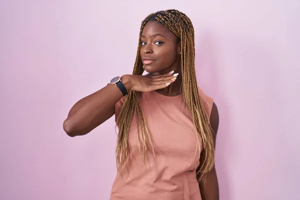 African American Woman Braided Hair Standing Pink Background Cutting Throat — Zdjęcie stockowe