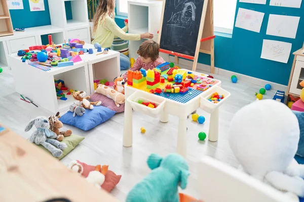 Teacher Toddler Playing Construction Blocks Sitting Table Kindergarten —  Fotos de Stock