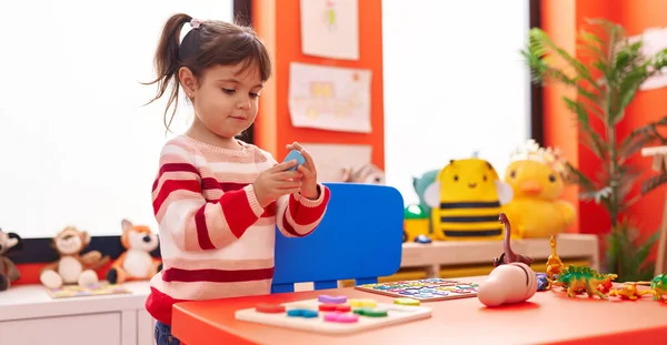 Adorable Hispanic Girl Playing Maths Puzzle Game Standing Kindergarten — Stockfoto