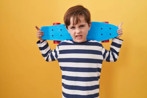 Menino Caucasiano Segurando Skate Sobre Fundo Amarelo Sem Noção Expressão — Fotografia de Stock