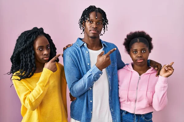 Группа Трех Молодых Черных Людей Стоящих Вместе Розовом Фоне Указывая — стоковое фото