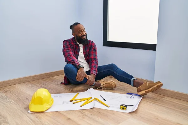 African American Man Sitting Floor New Home Looking Blueprints Looking — Stock Photo, Image