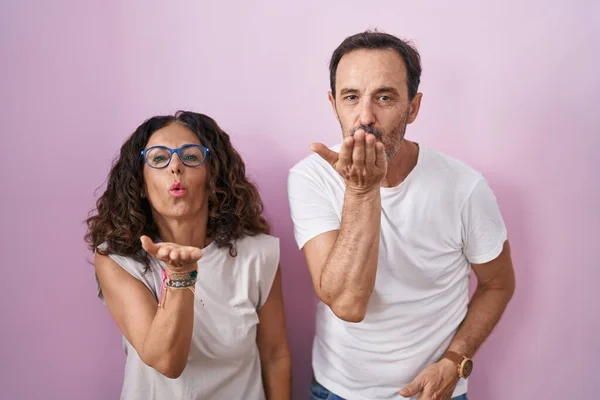 Middle Age Hispanic Couple Together Pink Background Looking Camera Blowing — Stock Photo, Image