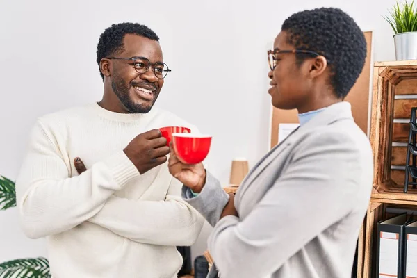 stock image Man and woman business workers drinking coffee at office