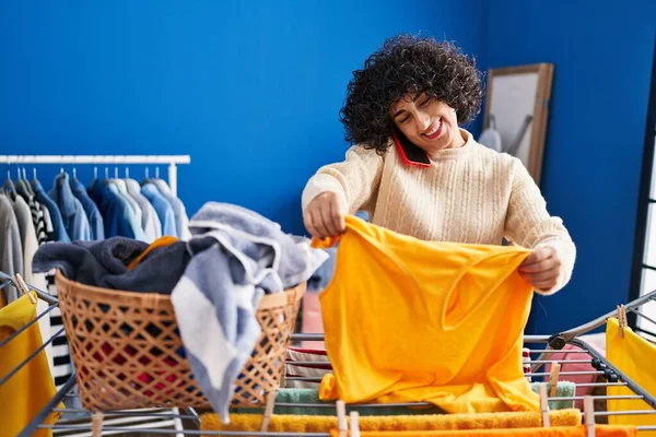 Young Middle East Woman Talking Smartphone Hanging Clothes Clothesline Laundry — Stockfoto