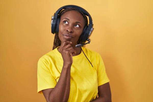 African American Woman Listening Music Using Headphones Hand Chin Thinking — Stock Photo, Image
