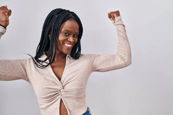African Woman Braids Standing White Background Showing Arms Muscles Smiling — Stockfoto