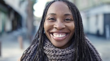 African woman smiling confident at street