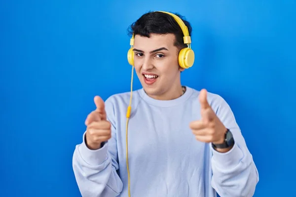 Non Binary Person Listening Music Using Headphones Pointing Fingers Camera — Stock Photo, Image