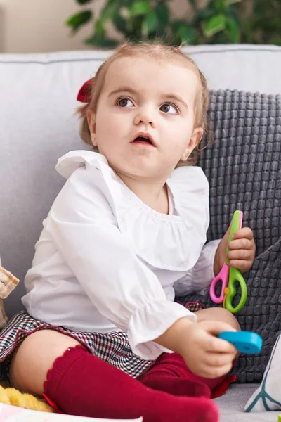 Adorable Blonde Toddler Holding Scissors Sitting Sofa Home — Stock Photo, Image