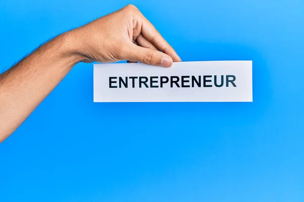Hand Caucasian Man Holding Paper Entrepreneur Word Isolated Blue Background — Stock fotografie