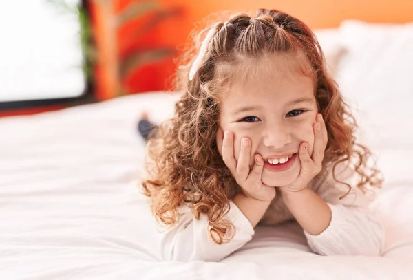 stock image Adorable blonde toddler smiling confident lying on bed at bedroom