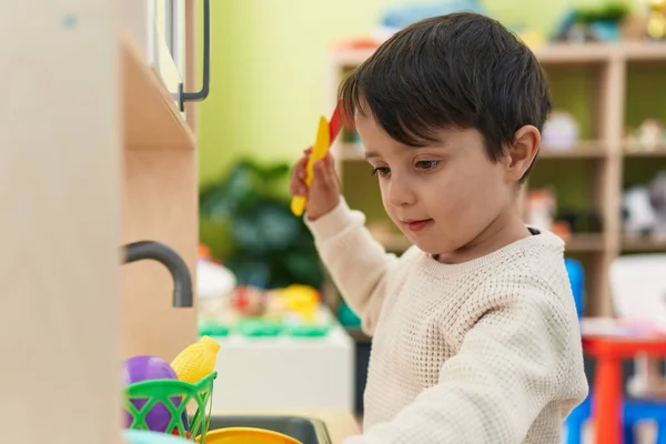 Adorable Hispanic Boy Playing Play Kitchen Standing Kindergarten — Fotografia de Stock