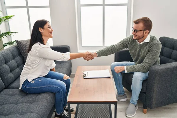Man and woman psychology and patient having psychologist session shake hands at psychology clinic