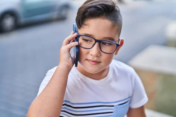 Adorable Hispanic Boy Talking Smartphone Sitting Bench Street — Stock Photo, Image