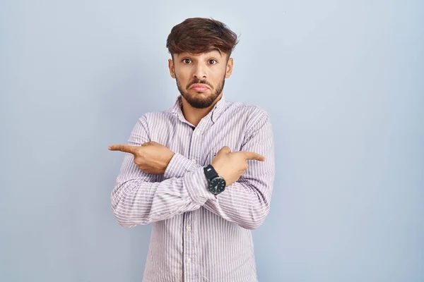 Arab Man Beard Standing Blue Background Pointing Both Sides Fingers — Foto Stock