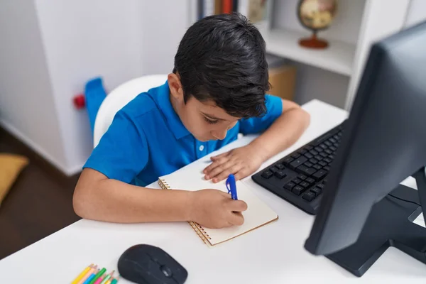 Adorable Hispanic Boy Student Using Computer Writing Notebook Classroom — Stockfoto