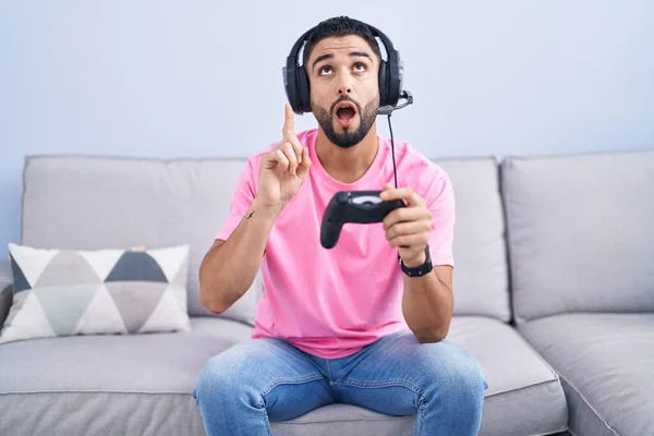 Hispanic Young Man Playing Video Game Holding Controller Sitting Sofa — Zdjęcie stockowe