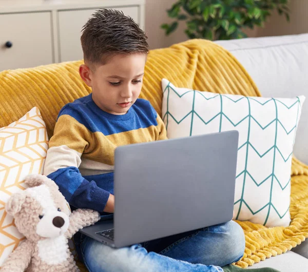 Adorable Hispanic Boy Using Laptop Sitting Sofa Home — Stok fotoğraf