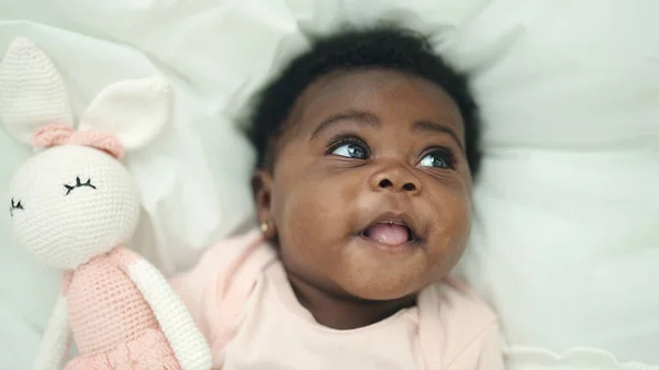 非洲裔美国婴儿笑着自信地躺在床上卧室里 — 图库照片