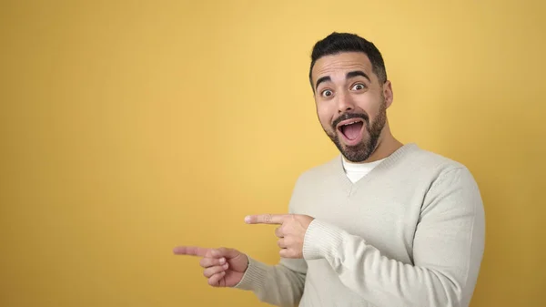 Young Hispanic Man Smiling Confident Pointing Fingers Side Isolated Yellow — Stock Photo, Image