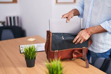 Young arab man business worker holding laptop at office