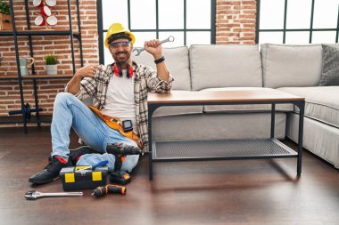 Young hispanic man with beard working on moving service pointing finger to one self smiling happy and proud 