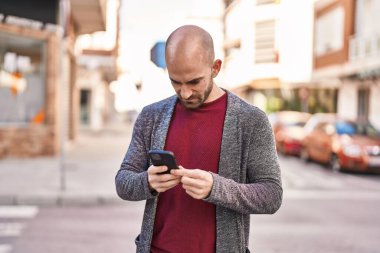 Young man using smartphone at street