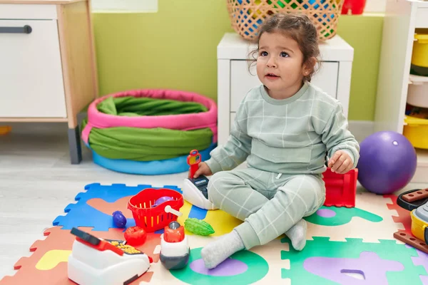 Adorable Hispanic Toddler Playing Supermarket Toy Sitting Floor Kindergarten — Stok fotoğraf