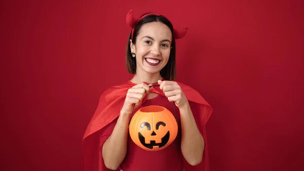 Young Beautiful Hispanic Woman Wearing Devil Costume Holding Halloween Pumpkin — Stok fotoğraf