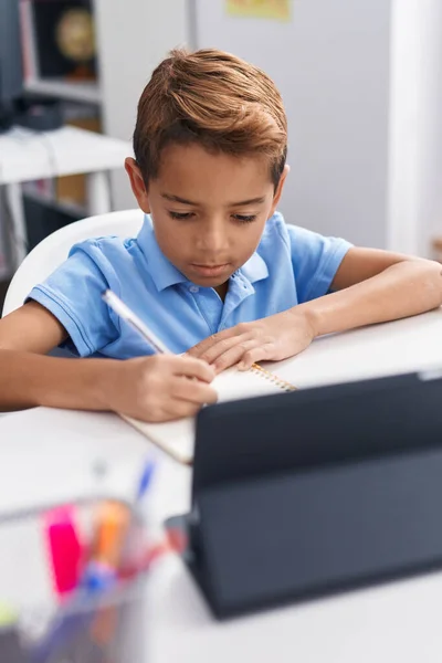 Adorable Hispanic Boy Student Sitting Table Doing Homework Classroom — 图库照片