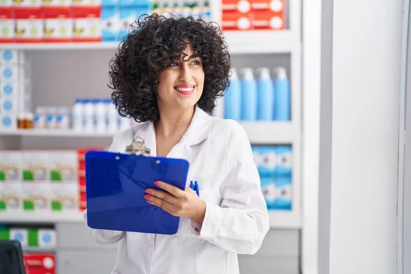 Young Middle East Woman Pharmacist Smiling Confident Writing Document Pharmacy — ストック写真