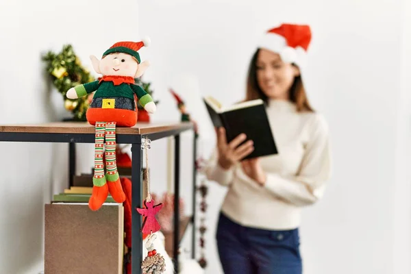 Middle Age Hispanic Woman Reading Book Standing Christmas Decor Home — Stock Photo, Image