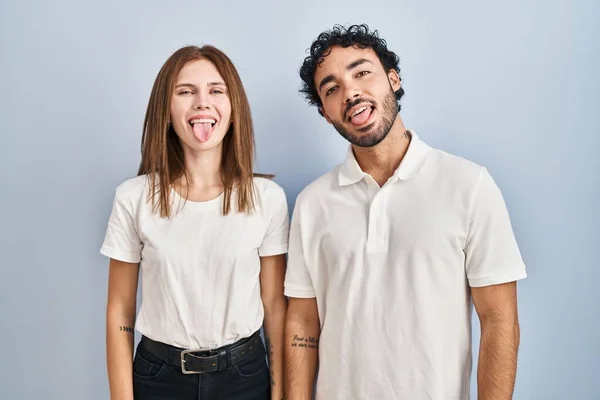 Young Couple Wearing Casual Clothes Standing Together Sticking Tongue Out — Photo