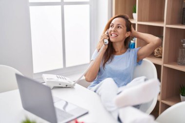 Young woman smiling confident teleworking at home