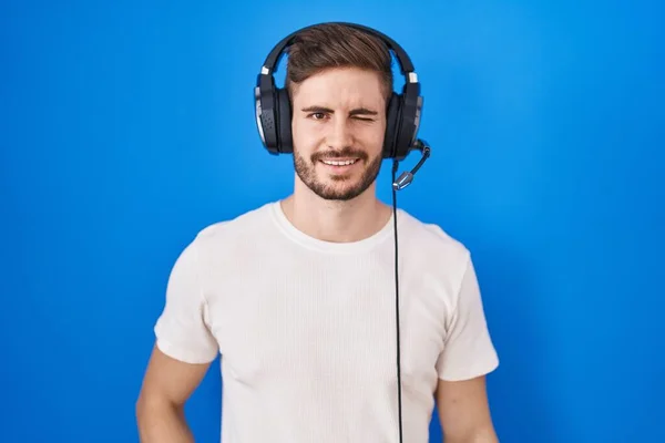 Hispanic Man Beard Listening Music Wearing Headphones Winking Looking Camera — ストック写真