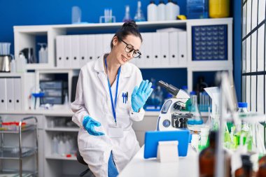 Young caucasian woman scientist having video call at laboratory