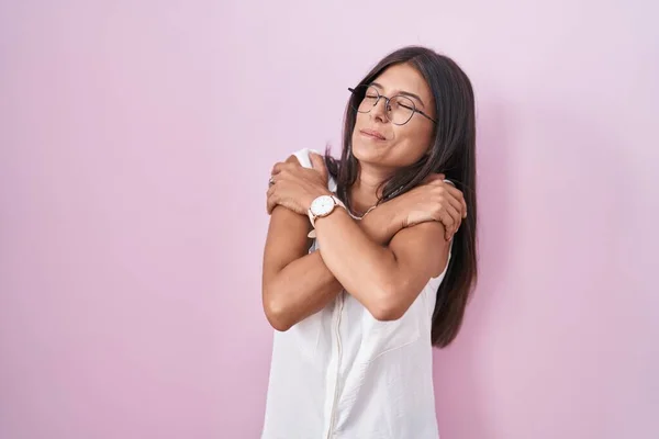 Молода Жінка Стоїть Над Рожевим Фоном Обнімає Себе Щасливими Позитивними — стокове фото