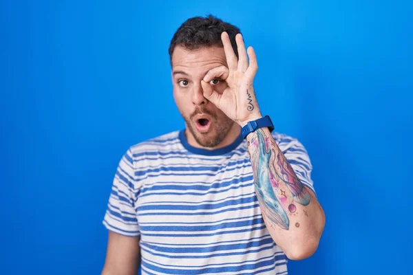 Young Hispanic Man Standing Blue Background Doing Gesture Shocked Surprised —  Fotos de Stock
