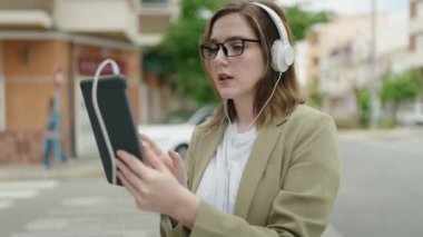 Young woman business worker having video call at street