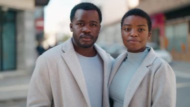 African american couple smiling confident hugging each other at street