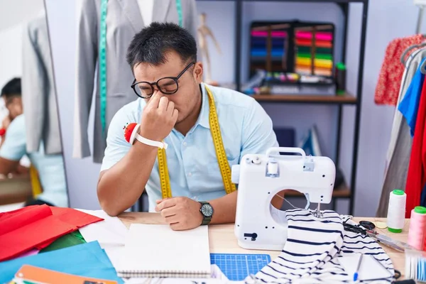 Young Chinese Man Tailor Stressed Sitting Table Tailor Shop — Stockfoto