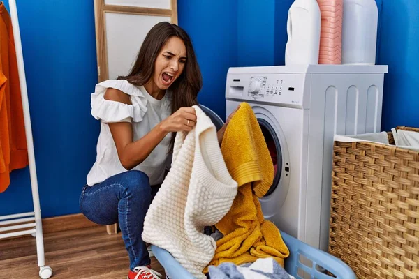 Young Hispanic Woman Putting Dirty Laundry Washing Machine Angry Mad — Stok fotoğraf