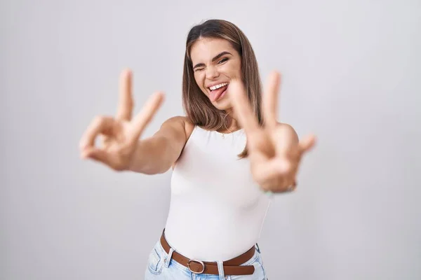 Hispanic Young Woman Standing White Background Smiling Tongue Out Showing — 图库照片