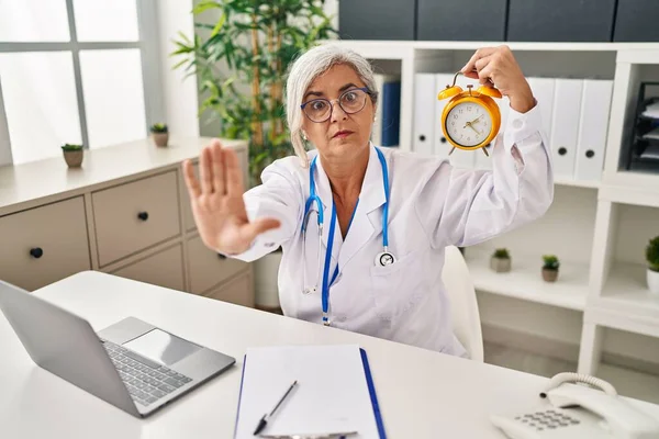 Middle Age Woman Grey Hair Wearing Doctor Uniform Holding Alarm — Stockfoto