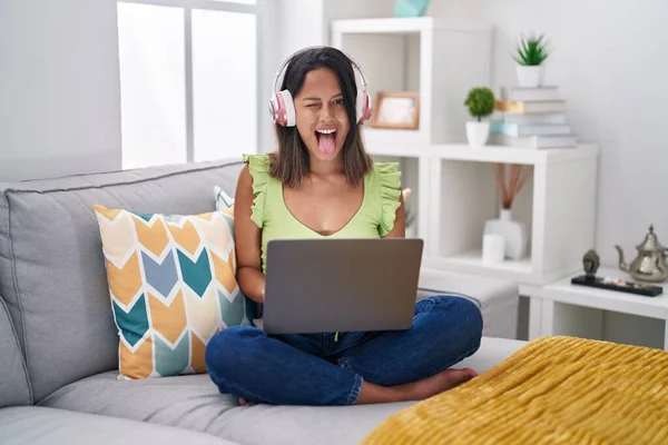 Hispanic Young Woman Using Laptop Home Sticking Tongue Out Happy — 스톡 사진