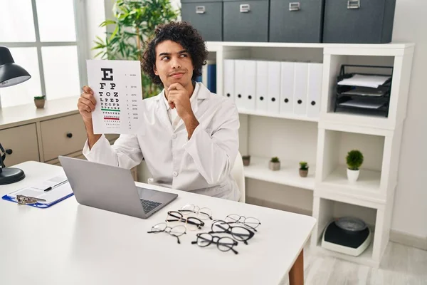 Hispanic Man Curly Hair Holding Eyesight Medical Exam Serious Face — Fotografia de Stock
